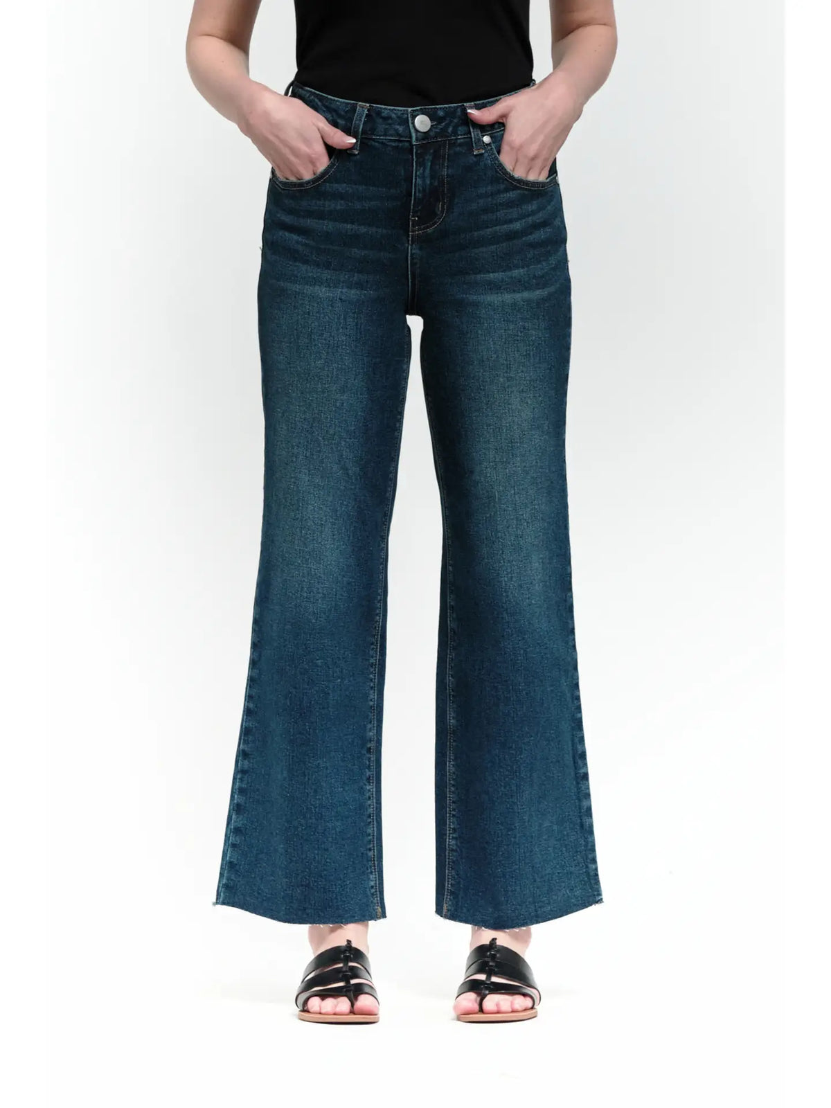 Person wearing blue jeans on a white background