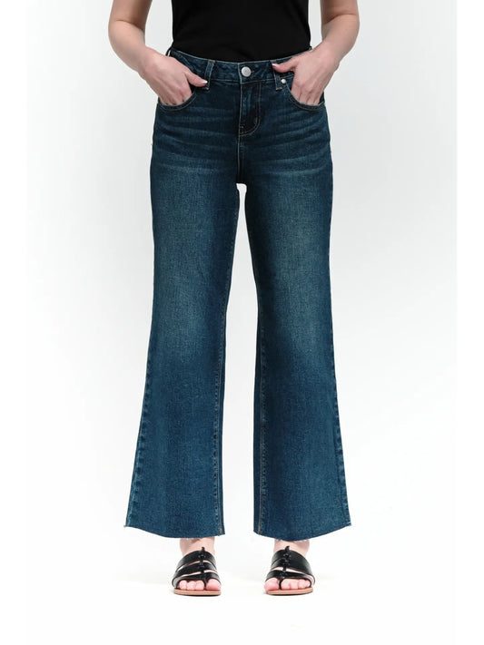 Person wearing blue jeans on a white background